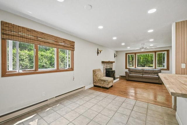 175 Armsby Rd, Sutton, MA 01590 - living area with a baseboard radiator, recessed lighting, light tile patterned flooring, ceiling fan, and a fireplace