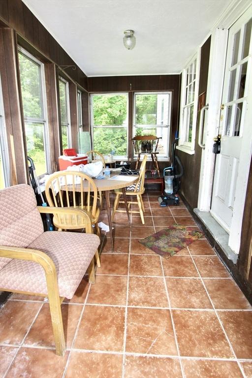 554 Wachusett St, Holden, MA 01520 - sunroom / solarium featuring tile patterned flooring and wood walls