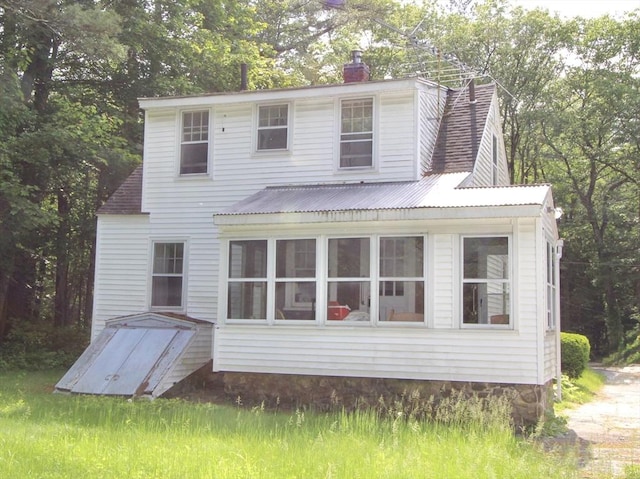 554 Wachusett St, Holden, MA 01520 - back of house featuring a chimney and view of wooded area
