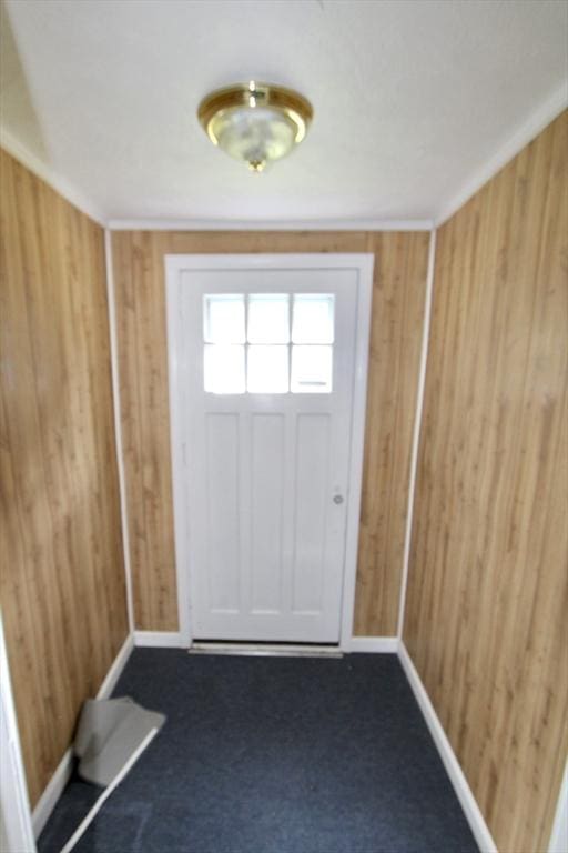 554 Wachusett St, Holden, MA 01520 - doorway featuring wooden walls, baseboards, and carpet