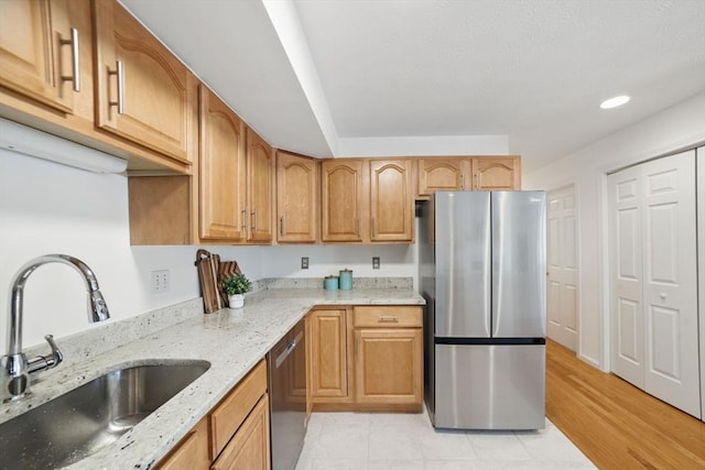 7 Conant Rd Unit 23, Winchester, MA 01890 - kitchen featuring appliances with stainless steel finishes, a sink, light stone counters, light tile patterned flooring, and recessed lighting