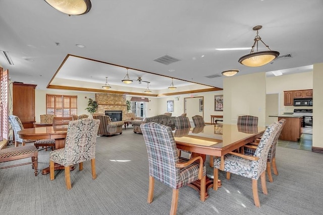 7 Conant Rd Unit 23, Winchester, MA 01890 - dining room featuring a raised ceiling, a fireplace, and light colored carpet