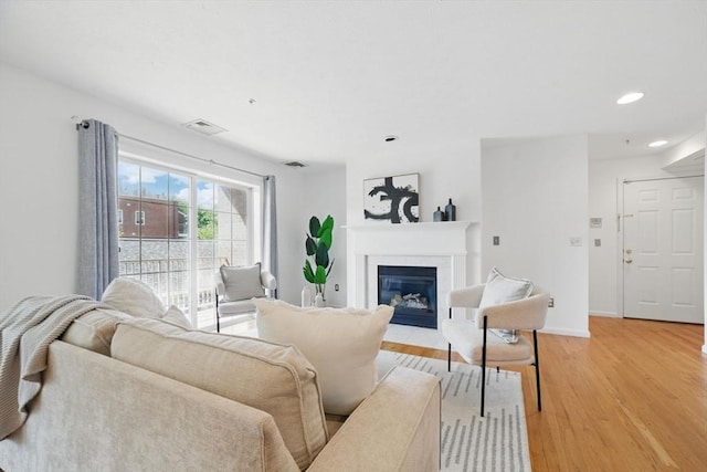 7 Conant Rd Unit 23, Winchester, MA 01890 - living area featuring light wood finished floors, a fireplace with flush hearth, recessed lighting, and baseboards