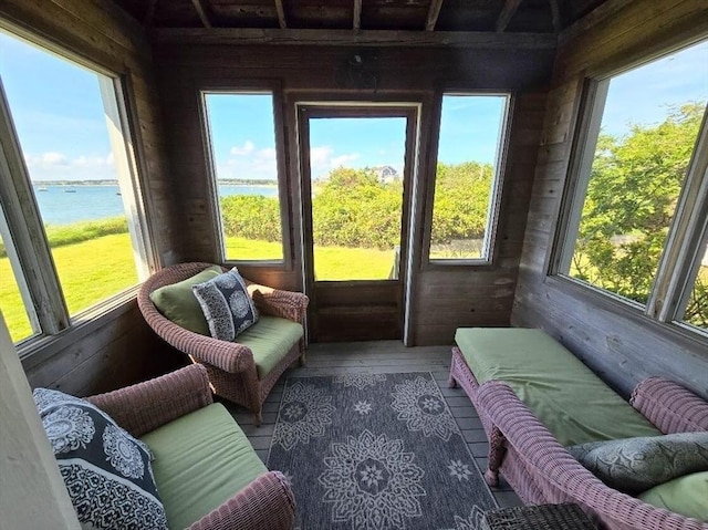 sunroom featuring a water view and a wealth of natural light