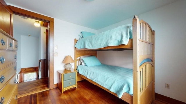 bedroom with dark wood-type flooring