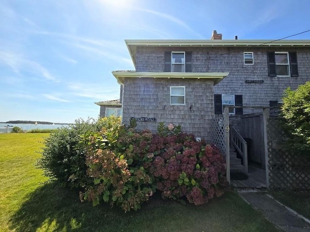 view of home's exterior with a lawn