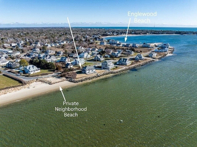 birds eye view of property featuring a beach view and a water view