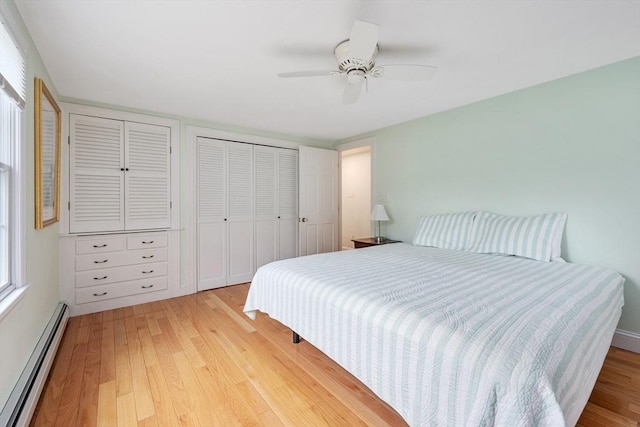 bedroom featuring a baseboard radiator, light wood finished floors, and a ceiling fan
