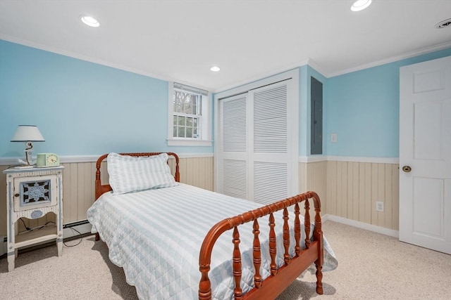bedroom featuring a wainscoted wall, a closet, ornamental molding, carpet floors, and recessed lighting