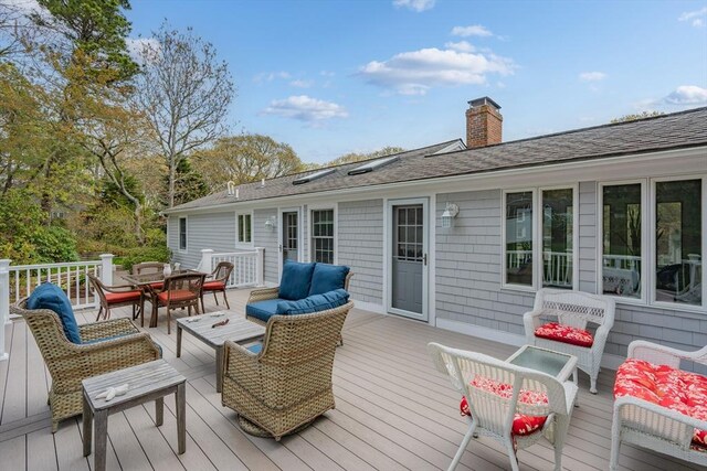 wooden terrace featuring an outdoor hangout area and outdoor dining space