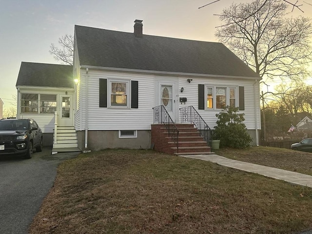 new england style home featuring a yard