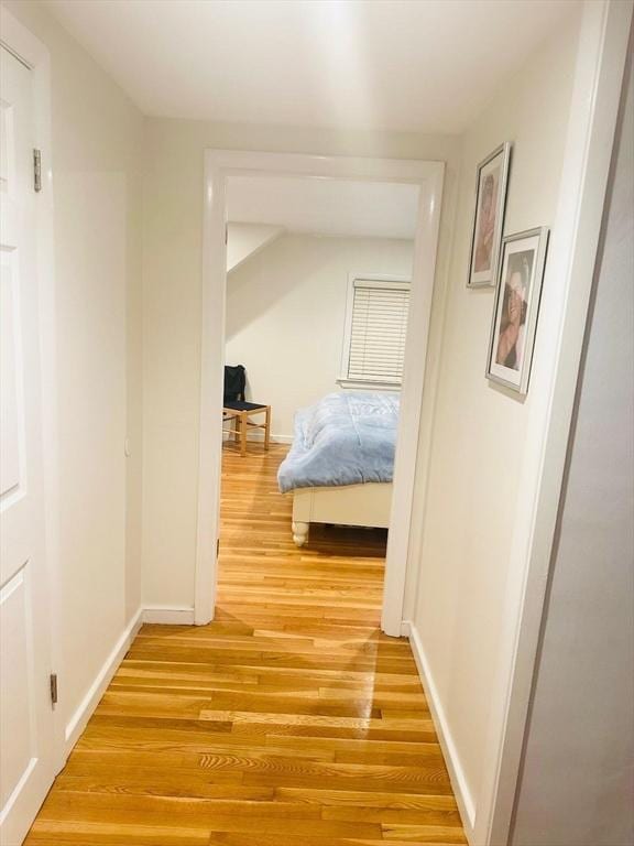 corridor with wood-type flooring