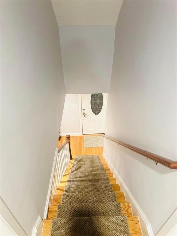 stairs with hardwood / wood-style flooring