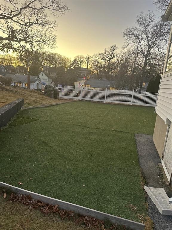 view of yard at dusk