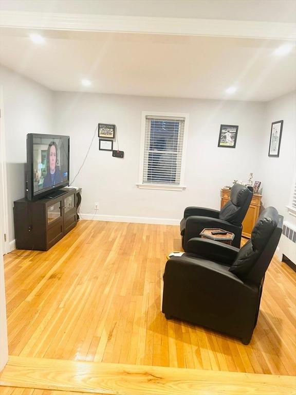 living room featuring hardwood / wood-style flooring and radiator