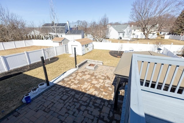 view of patio / terrace with a residential view, an outbuilding, and a fenced backyard