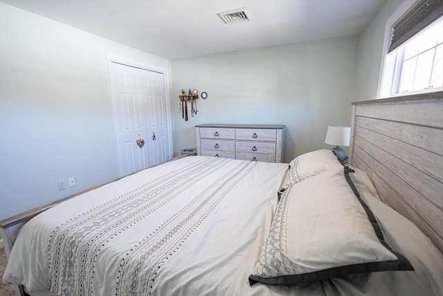 bedroom with visible vents and a closet