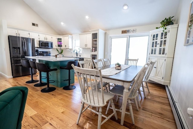 dining room featuring visible vents, high vaulted ceiling, light wood-style flooring, recessed lighting, and baseboard heating