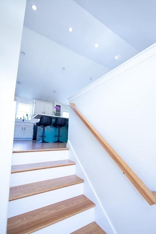 stairway with recessed lighting and wood finished floors