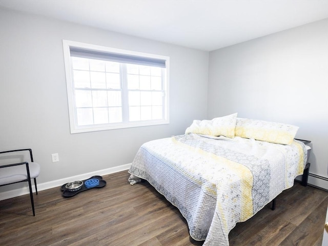 bedroom featuring wood finished floors and baseboards