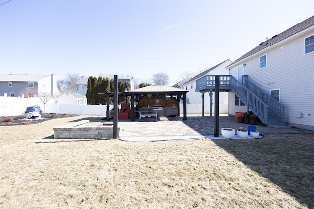 view of yard with stairs, a gazebo, fence, and a patio