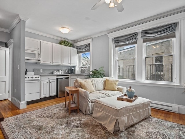 interior space with baseboard heating, crown molding, ceiling fan, and hardwood / wood-style flooring