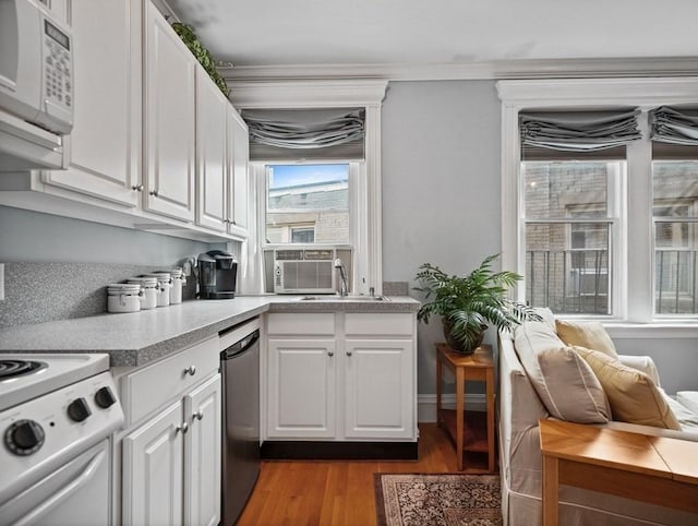 kitchen featuring cooling unit, white cabinets, white appliances, and light wood-type flooring