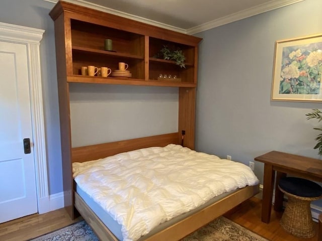 bedroom with hardwood / wood-style flooring and ornamental molding