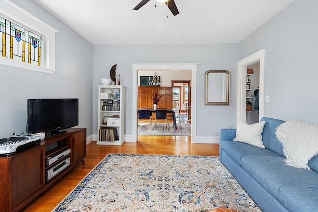 living room with ceiling fan and hardwood / wood-style flooring