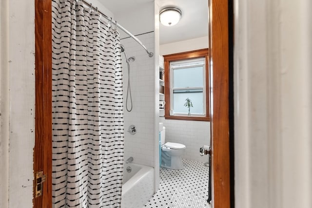 bathroom with toilet and shower / bath combo with shower curtain