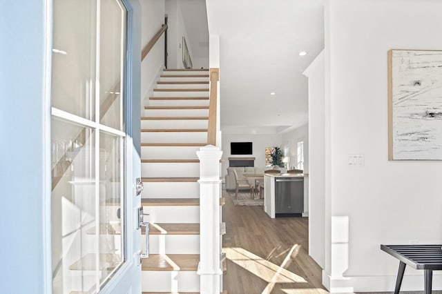 stairs with wood-type flooring