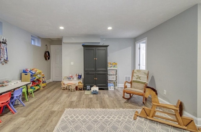 recreation room with recessed lighting, baseboards, and light wood finished floors