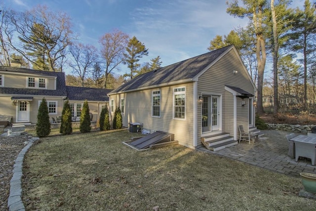 back of house with a patio area, a lawn, central AC unit, and entry steps