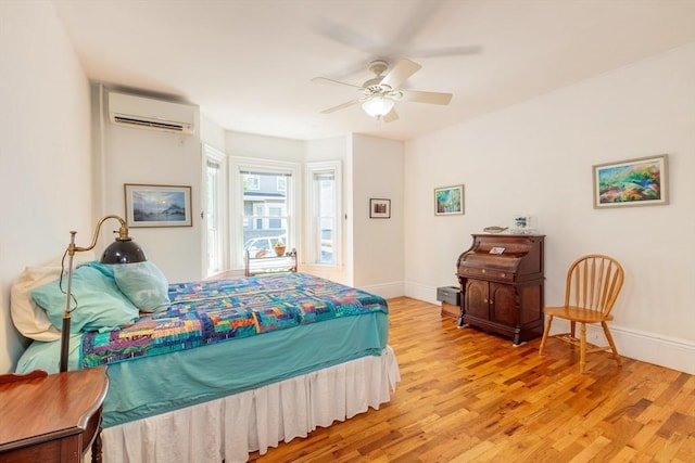 13 Sargent Ave Unit 1, Somerville, MA 02145 - bedroom with a wall mounted air conditioner, light wood-style flooring, and a ceiling fan
