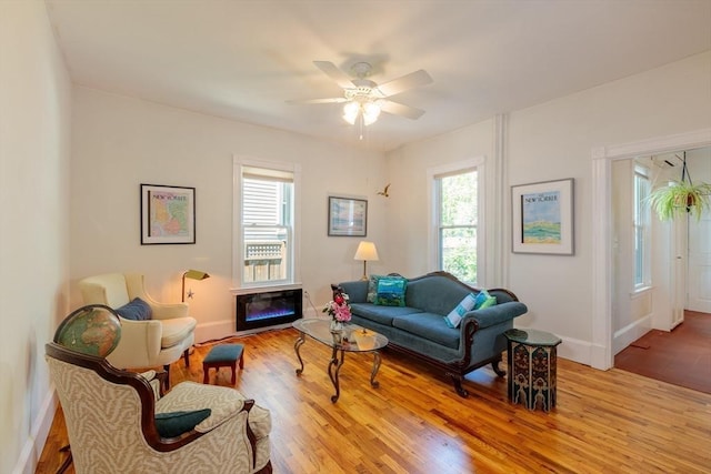 13 Sargent Ave Unit 1, Somerville, MA 02145 - living area with healthy amount of natural light, light wood-style floors, ceiling fan, and a glass covered fireplace