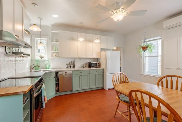13 Sargent Ave Unit 1, Somerville, MA 02145 - kitchen with appliances with stainless steel finishes, open shelves, green cabinets, and tasteful backsplash