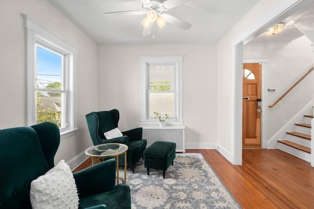 127 Highland Ave, Watertown, MA 02472 - sitting room featuring healthy amount of natural light, wood finished floors, stairs, and a ceiling fan