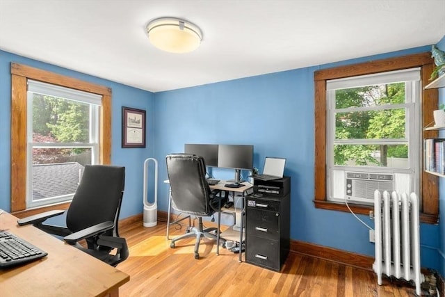 127 Highland Ave, Watertown, MA 02472 - office area featuring radiator heating unit, healthy amount of natural light, wood finished floors, and baseboards