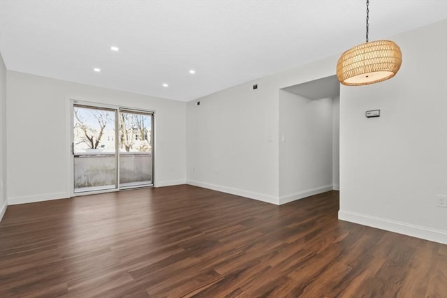 unfurnished room with dark wood-type flooring