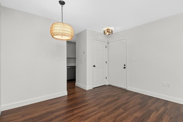 unfurnished room with dark wood-type flooring