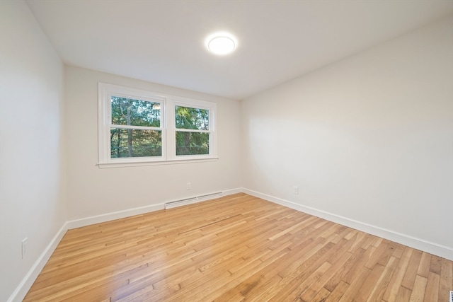 spare room with light hardwood / wood-style flooring and baseboard heating