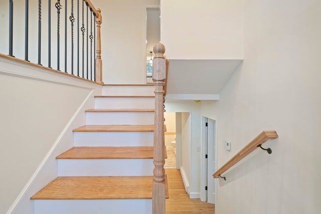 staircase with wood-type flooring