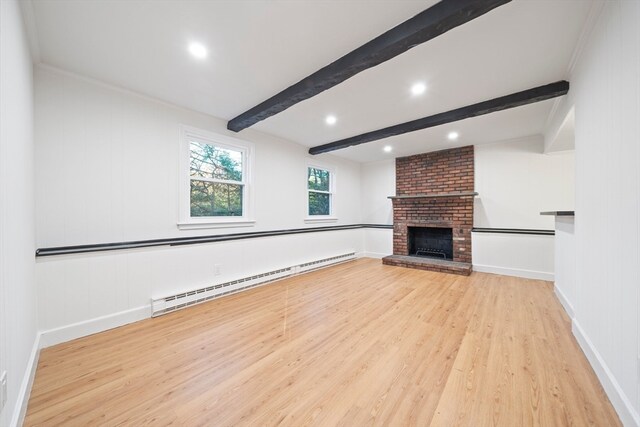 unfurnished living room featuring light hardwood / wood-style flooring, beam ceiling, a brick fireplace, crown molding, and a baseboard radiator