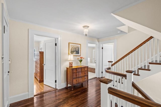 entryway with ornamental molding and dark hardwood / wood-style flooring