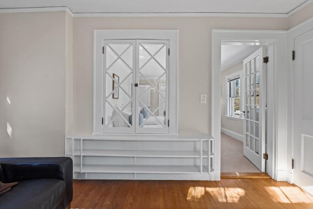 interior space with crown molding and wood-type flooring