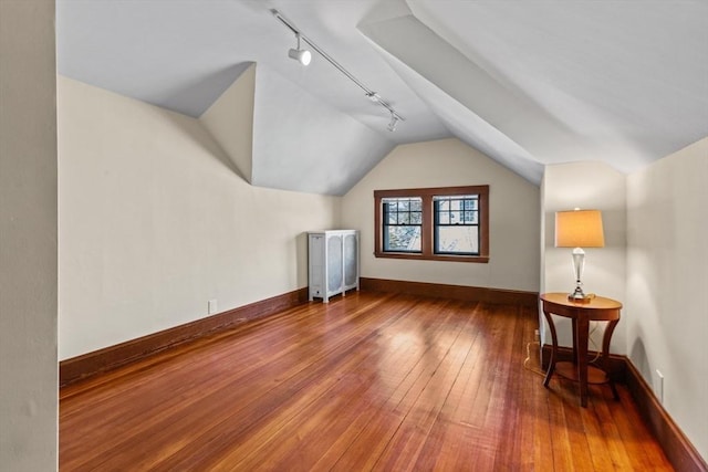 additional living space featuring lofted ceiling and hardwood / wood-style floors