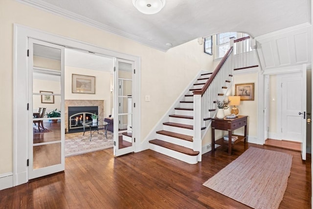 foyer featuring crown molding and dark hardwood / wood-style flooring