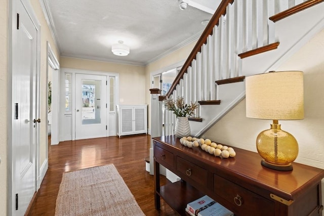 foyer entrance featuring crown molding and dark hardwood / wood-style floors