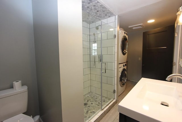 271 Gibson St, Lowell, MA 01851 - full bathroom with estacked washer and dryer, a shower stall, toilet, and vanity
