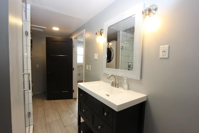 271 Gibson St, Lowell, MA 01851 - bathroom with estacked washer and dryer and vanity